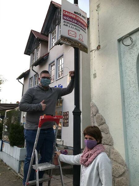 Das Foto zeigt Iris Wetzel und Justin Köhler bei der Plakataktion in Calden am letzten Donnerstag